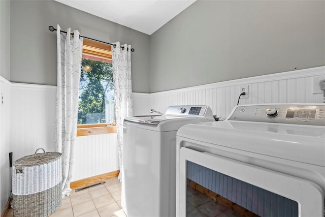 207 High Acres Rd, Lancaster Twp, PA 16037 - laundry room with a wainscoted wall, washing machine and clothes dryer, and light tile patterned floors
