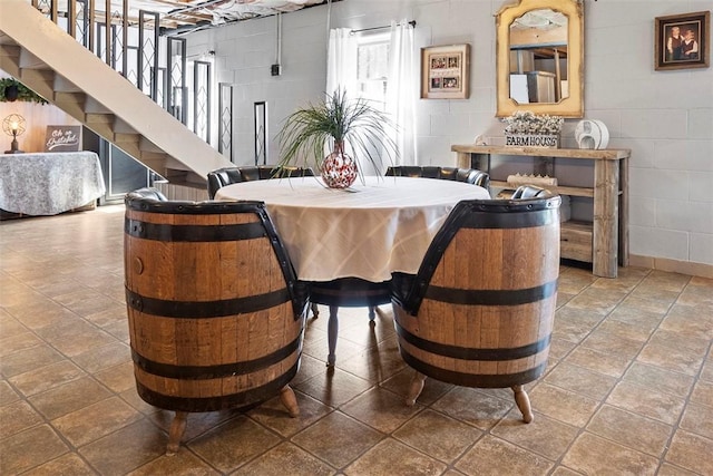 207 High Acres Rd, Lancaster Twp, PA 16037 - dining room featuring concrete block wall and stairway