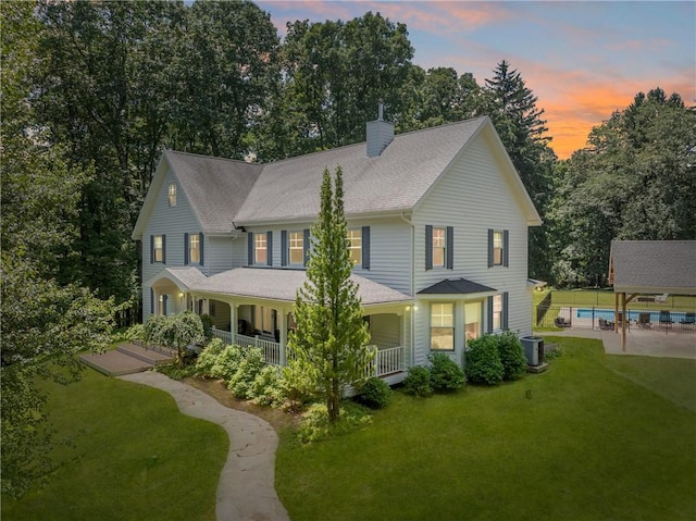 16 Mcdowell Rd, Ligonier Twp, PA 15658 - view of front facade featuring a chimney, a front yard, and covered porch