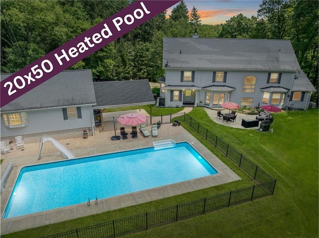 16 Mcdowell Rd, Ligonier Twp, PA 15658 - pool at dusk featuring a water slide, a patio, a fire pit, a fenced backyard, and a gazebo