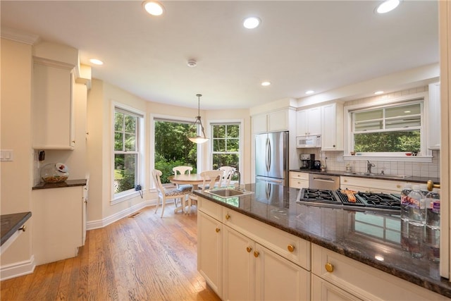 16 Mcdowell Rd, Ligonier Twp, PA 15658 - kitchen with appliances with stainless steel finishes, light wood-style floors, backsplash, pendant lighting, and recessed lighting