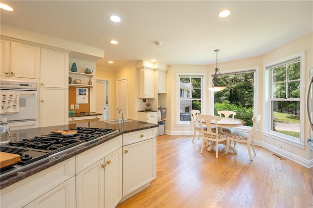 16 Mcdowell Rd, Ligonier Twp, PA 15658 - kitchen with recessed lighting, pendant lighting, light wood finished floors, black gas cooktop, and open shelves