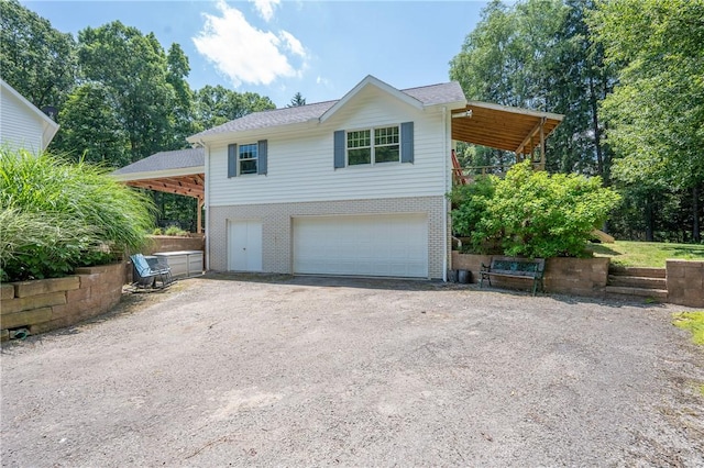 16 Mcdowell Rd, Ligonier Twp, PA 15658 - view of front facade with dirt driveway, a garage, and brick siding