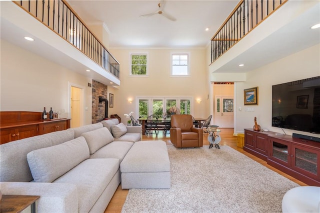 16 Mcdowell Rd, Ligonier Twp, PA 15658 - living area featuring a towering ceiling, wood finished floors, crown molding, ceiling fan, and recessed lighting