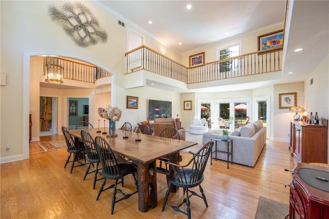 16 Mcdowell Rd, Ligonier Twp, PA 15658 - dining space featuring a towering ceiling, light wood-style flooring, arched walkways, recessed lighting, and ornamental molding