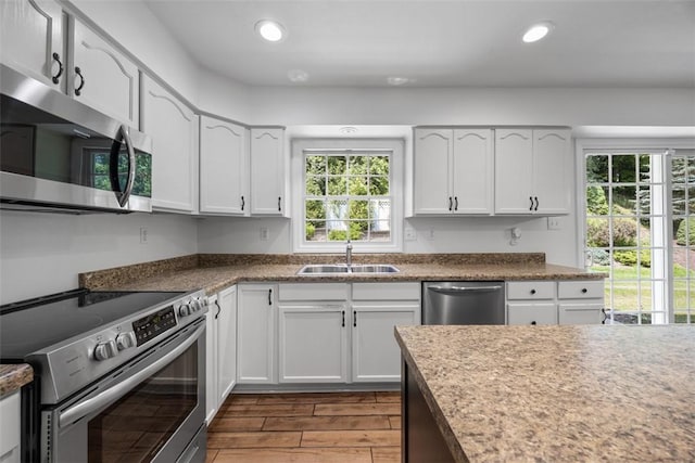 116 Stonegate Dr, North Strabane, PA 15317 - kitchen with stainless steel appliances, plenty of natural light, wood finished floors, white cabinetry, and recessed lighting