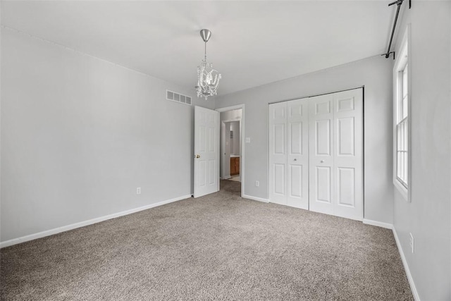 116 Stonegate Dr, North Strabane, PA 15317 - unfurnished bedroom featuring a chandelier, carpet floors, a closet, and multiple windows