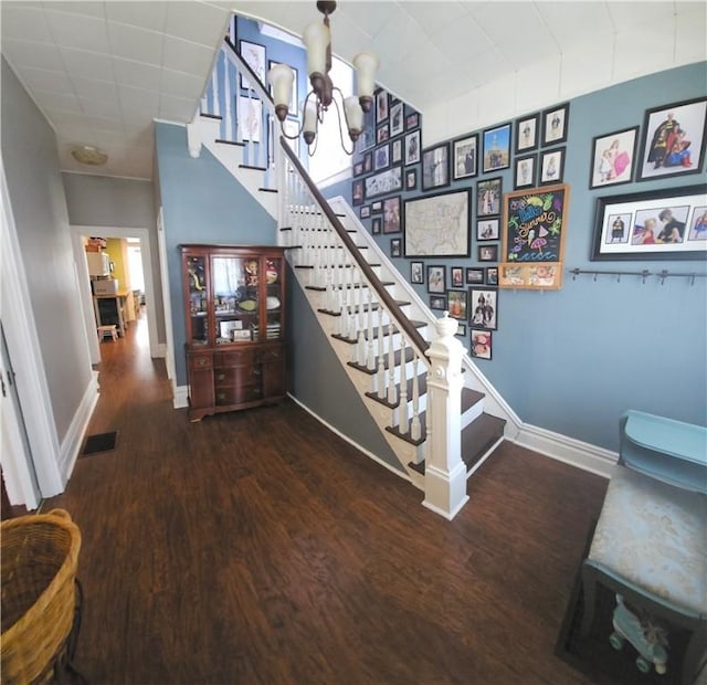 216 N Sprague Ave, Bellevue, PA 15202 - staircase featuring wood finished floors and a chandelier