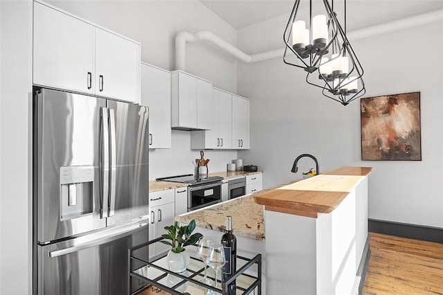 3080 Smallman St, Downtown Pgh, PA 15201 - kitchen featuring stainless steel appliances, a chandelier, an island with sink, and white cabinetry