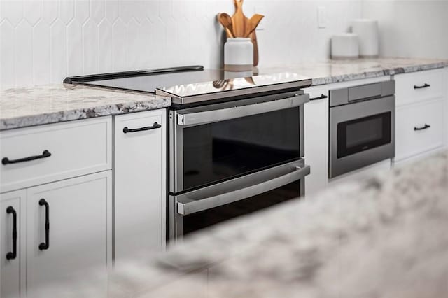 3080 Smallman St, Downtown Pgh, PA 15201 - kitchen featuring appliances with stainless steel finishes, white cabinetry, and light stone countertops