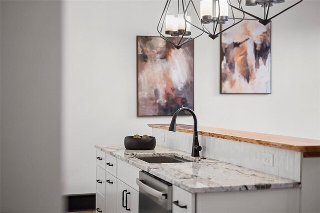3080 Smallman St, Downtown Pgh, PA 15201 - kitchen with dishwasher, a chandelier, white cabinetry, light stone counters, and hanging light fixtures