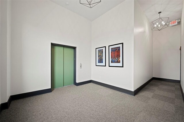 3080 Smallman St, Downtown Pgh, PA 15201 - spare room featuring elevator, a chandelier, dark colored carpet, and a high ceiling