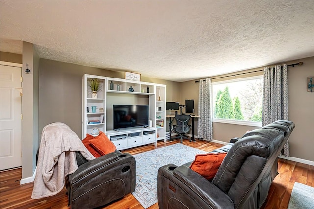 221 Wheatfield Dr, Hempfield Twp, PA 15601 - living room featuring a textured ceiling and wood finished floors