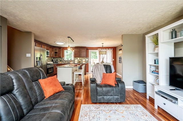 221 Wheatfield Dr, Hempfield Twp, PA 15601 - living area featuring dark wood-style flooring and a textured ceiling