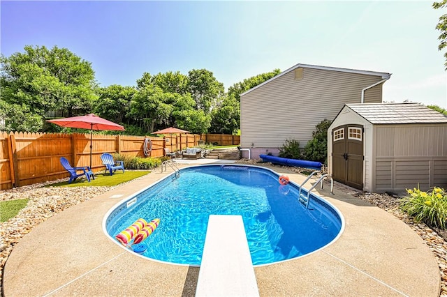 221 Wheatfield Dr, Hempfield Twp, PA 15601 - view of pool featuring a storage unit, a fenced backyard, a diving board, and a patio area