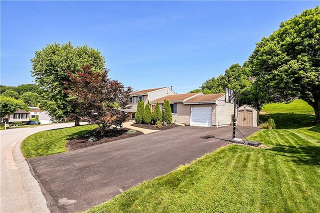 221 Wheatfield Dr, Hempfield Twp, PA 15601 - view of front of home with driveway, an attached garage, a shed, and a front lawn