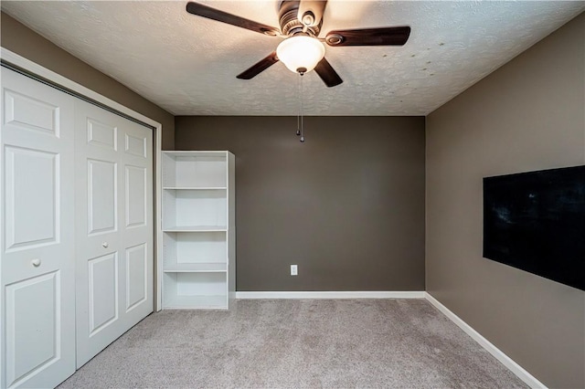 221 Wheatfield Dr, Hempfield Twp, PA 15601 - unfurnished bedroom with a textured ceiling, carpet, a closet, and a ceiling fan