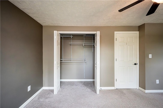 221 Wheatfield Dr, Hempfield Twp, PA 15601 - unfurnished bedroom with a closet, a textured ceiling, carpet flooring, and a ceiling fan