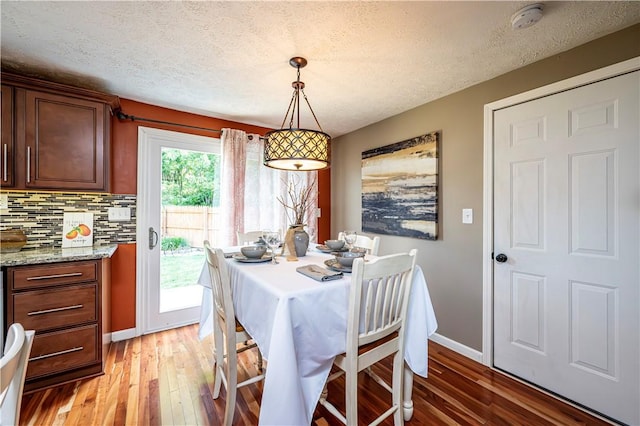 221 Wheatfield Dr, Hempfield Twp, PA 15601 - dining area featuring light wood finished floors and a textured ceiling