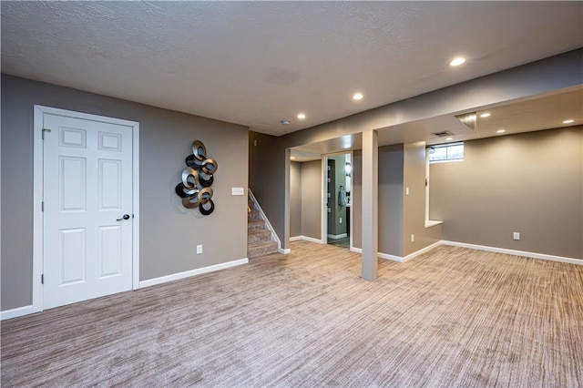 221 Wheatfield Dr, Hempfield Twp, PA 15601 - basement featuring light colored carpet, stairway, and recessed lighting