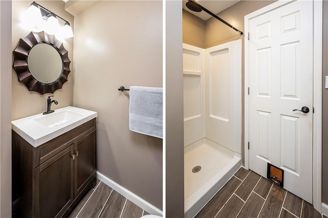221 Wheatfield Dr, Hempfield Twp, PA 15601 - bathroom with a stall shower, wood tiled floors, and vanity