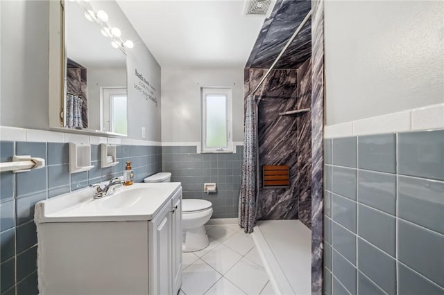1533 Missouri Ave, South Park, PA 15017 - bathroom with tile walls, tiled shower, tile patterned flooring, vanity, and a wainscoted wall