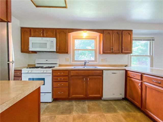 5380 Tuscarawas Rd, Brighton Twp, PA 15009 - kitchen with white appliances, brown cabinetry, and light countertops
