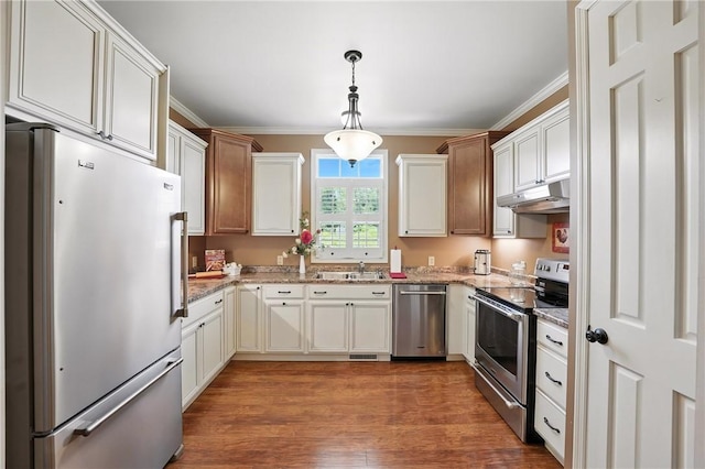 202 Ringneck Meadow Dr, Worth Twp, PA 16057 - kitchen featuring appliances with stainless steel finishes, under cabinet range hood, crown molding, wood finished floors, and light stone counters