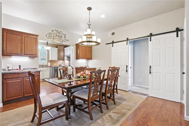202 Ringneck Meadow Dr, Worth Twp, PA 16057 - dining area with a barn door, light wood-style floors, and recessed lighting