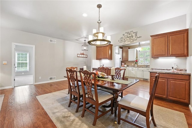 202 Ringneck Meadow Dr, Worth Twp, PA 16057 - dining space with light wood-style flooring and a chandelier