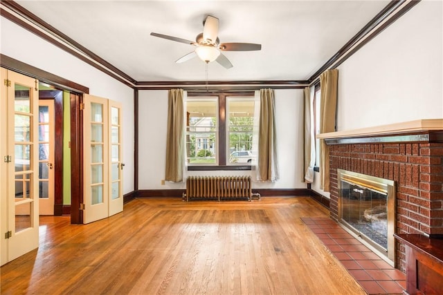 429 S Center Ave, Somerset Boro, PA 15501 - unfurnished living room with radiator heating unit, french doors, wood finished floors, a ceiling fan, and ornamental molding