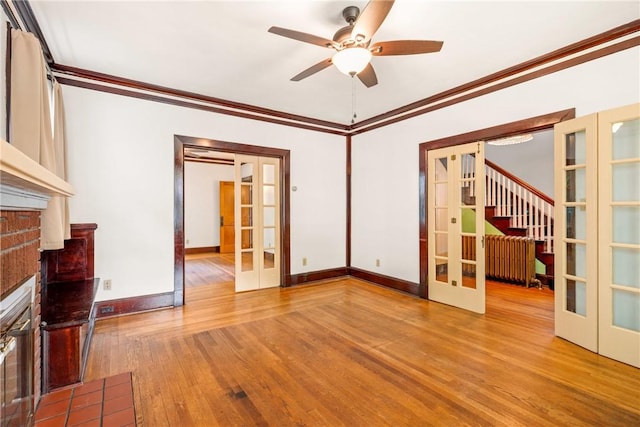 429 S Center Ave, Somerset Boro, PA 15501 - unfurnished living room featuring french doors, wood finished floors, a ceiling fan, crown molding, and a brick fireplace