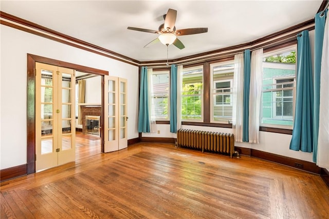 429 S Center Ave, Somerset Boro, PA 15501 - spare room featuring radiator, french doors, hardwood / wood-style floors, ornamental molding, and plenty of natural light