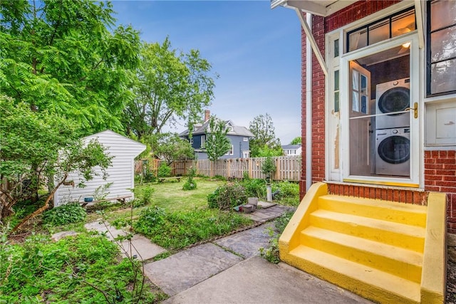 429 S Center Ave, Somerset Boro, PA 15501 - fenced backyard featuring stacked washer / dryer, entry steps, and a storage unit