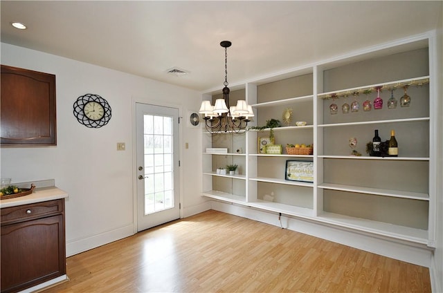 126 S Patton Dr, Moon/Crescent Twp, PA 15108 - unfurnished dining area with a chandelier and light wood-type flooring