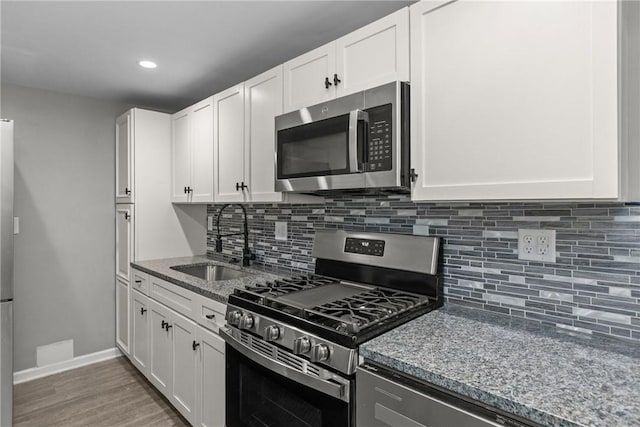 1022 2nd Ave, Coraopolis, PA 15108 - kitchen with appliances with stainless steel finishes, light stone counters, backsplash, white cabinetry, and recessed lighting