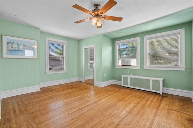 310 Columbia Ave, West View, PA 15229 - empty room with radiator heating unit, light wood finished floors, ceiling fan, and plenty of natural light