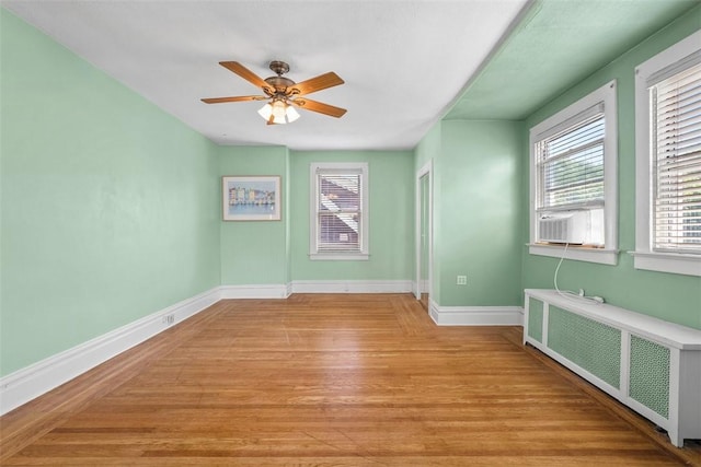310 Columbia Ave, West View, PA 15229 - unfurnished room featuring radiator heating unit, light wood-style floors, ceiling fan, and cooling unit