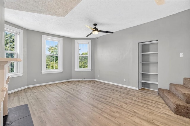 201 La Belle St, Mt Washington, PA 15211 - unfurnished living room with wood finished floors, plenty of natural light, a ceiling fan, stairway, and a textured ceiling