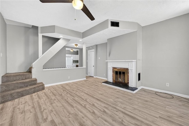 201 La Belle St, Mt Washington, PA 15211 - unfurnished living room featuring a ceiling fan, wood finished floors, stairs, and a fireplace