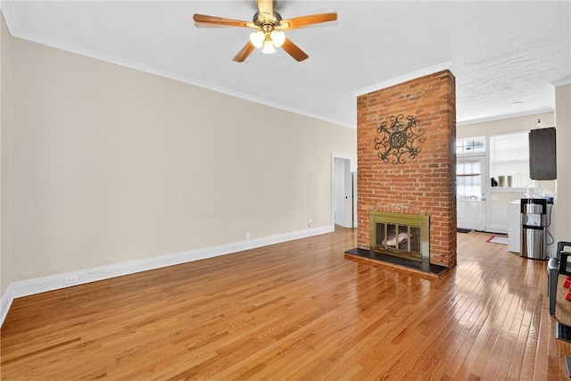 201 La Belle St, Mt Washington, PA 15211 - unfurnished living room featuring light wood-style flooring, a brick fireplace, a ceiling fan, and crown molding