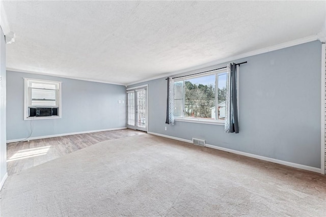 339 Foster Rd N, Versailles, PA 15137 - unfurnished room featuring cooling unit, ornamental molding, a textured ceiling, carpet floors, and wood finished floors