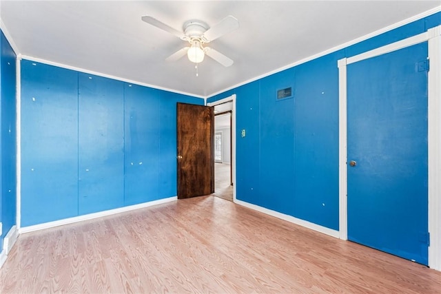 339 Foster Rd N, Versailles, PA 15137 - unfurnished bedroom featuring wood finished floors, crown molding, a closet, and ceiling fan
