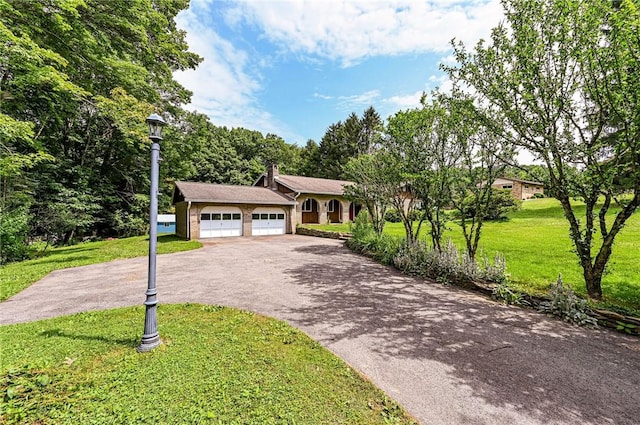 483 Twin Lakes Rd, Unity Twp, PA 15650 - view of front of property featuring driveway, an attached garage, a front lawn, a chimney, and brick siding