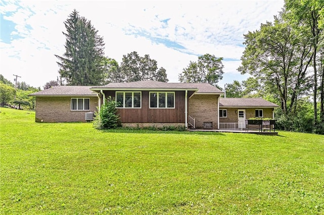 483 Twin Lakes Rd, Unity Twp, PA 15650 - view of front of property featuring a wooden deck, a front yard, and brick siding
