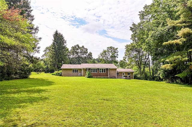 483 Twin Lakes Rd, Unity Twp, PA 15650 - view of front of house featuring a front yard and view of wooded area