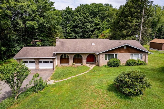 483 Twin Lakes Rd, Unity Twp, PA 15650 - view of front of property with asphalt driveway, an attached garage, a front lawn, brick siding, and roof with shingles