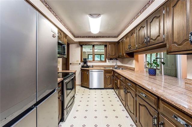 483 Twin Lakes Rd, Unity Twp, PA 15650 - kitchen with appliances with stainless steel finishes, light countertops, dark brown cabinetry, and light flooring