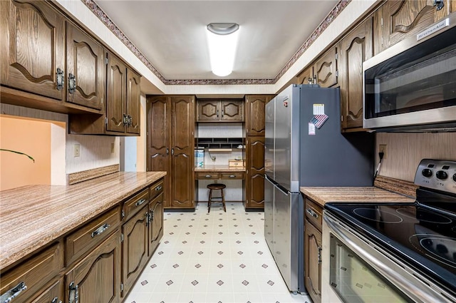 483 Twin Lakes Rd, Unity Twp, PA 15650 - kitchen featuring stainless steel appliances, light flooring, light countertops, and dark brown cabinetry