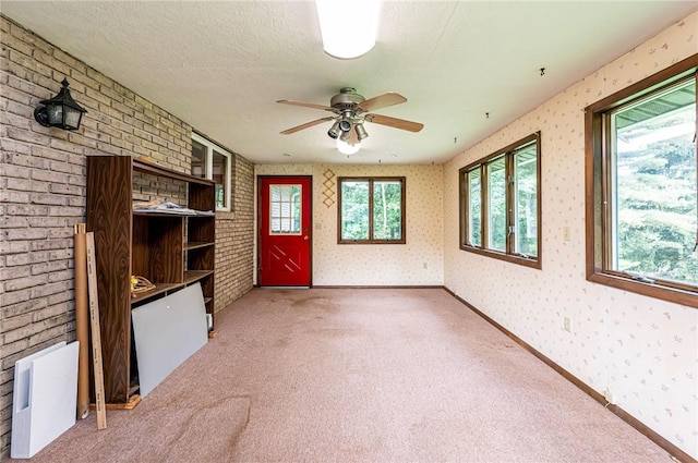 483 Twin Lakes Rd, Unity Twp, PA 15650 - unfurnished living room with light colored carpet, wallpapered walls, and ceiling fan